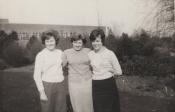 Julie Moore with 2 friends in Brtish Nylon Spinners  factory grounds; buses in background, that were free to staff
