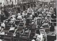 Factory floor at Morris Motors, showing the assembling of copper brass radiators; c. 1970. Carol Price is in the second row, wearing spectacles. 
